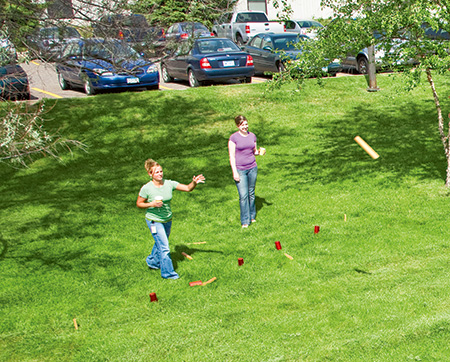 Kubb game being played outdoors