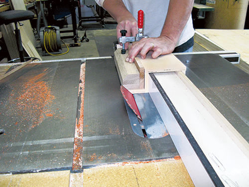Making octagonal cuts on kubb game pieces with bevel ripping jig on table saw