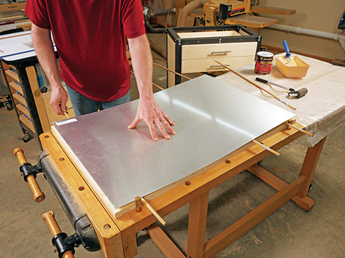 Laying out aluminum panel over shop cart tabletop