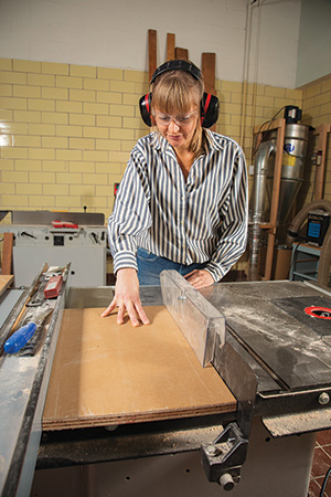 Cutting lending library blanks at a table saw