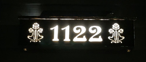 Solar powered house number at night