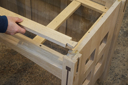 Attaching a rail with a dovetailed edge