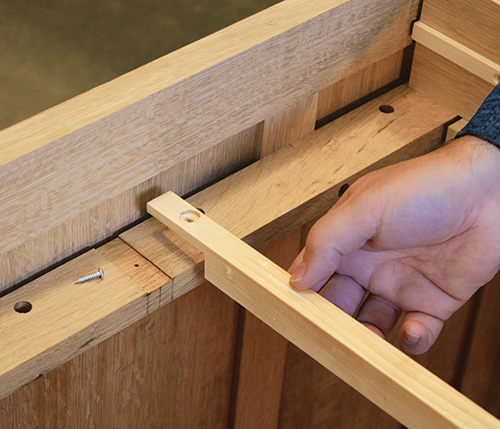 Adding center drawer guide into the web frame assembly