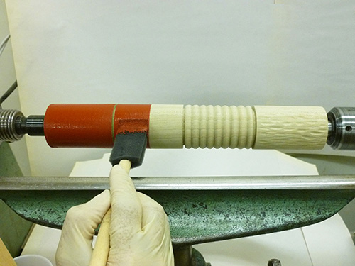 Applying base coat of paint to turned spindle