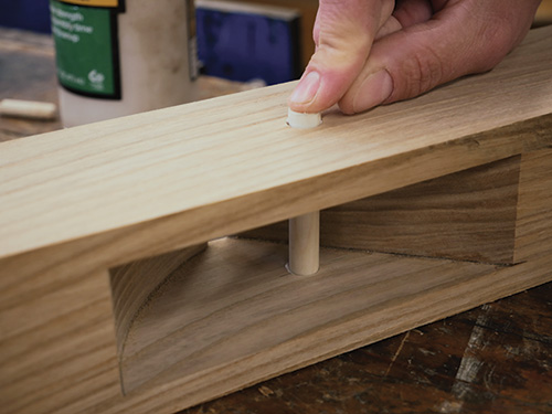 Gluing plane pin in place on wooden hand plane