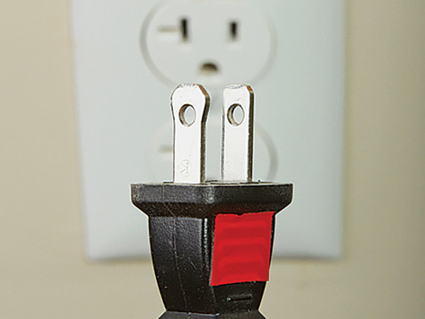 Piece of tape marking top of electric plug