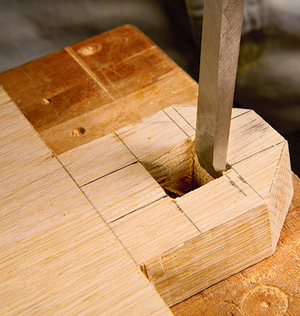 Chopping out mortise with hand-drawn guide