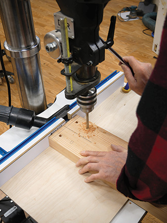 Drilling holes for installing caster bracket in lathe stand base