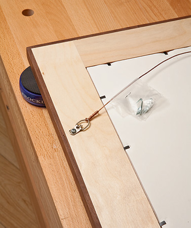 Attaching hangers to plywood mosaic picture frame