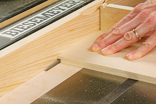 The ends of the drawer box fronts and backs receive a 1/4" rabbet that fts into the dadoes made in the drawer sides. A sacrifcial fence protects the rip fence here.