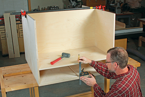Assembling the carcass parts “dry” not only helps you assess how things fi t together, it also gives you true references for marking joinery locations (like the drawer divider dado here) and determining fi nal part dimensions.