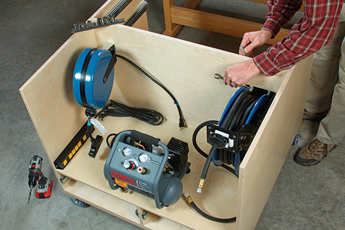 An extension cord reel (left) brings power to the cart’s outlet strip for the compressor and other corded tools or chargers. An air hose reel (right) allows nailers to be used at the cart or even a good distance from it.