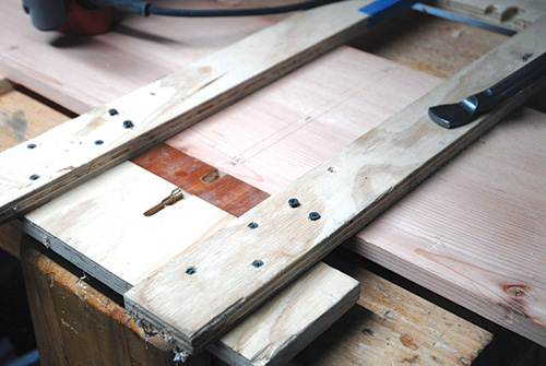 Shop-made jig for routing dadoes in a panel