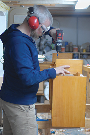 Drilling holes for chair glides in feet of Nakashima console