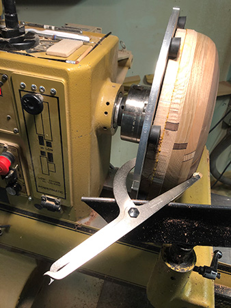 Nested bowl blank clamped against lathe chuck