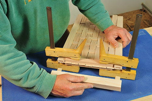 Pressing basket weaving in place in basket frame