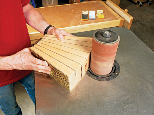 Smoothing top of knife block curve with drum sander