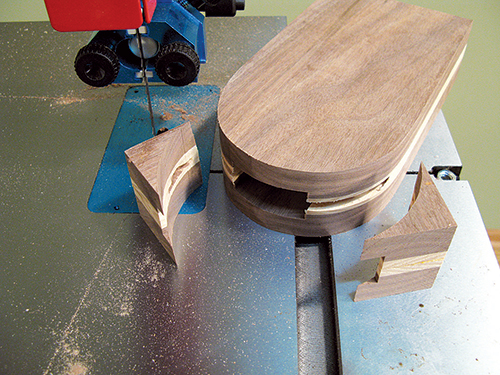 Band saw the arch to shape. If this cut doesn’t quite expose the long pizza cutter slot, as shown, sand the arch on a disc or drum sander until the slot opens up in the rim.