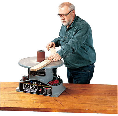 Removing marks on portable outdoor chair parts with a spindle sander