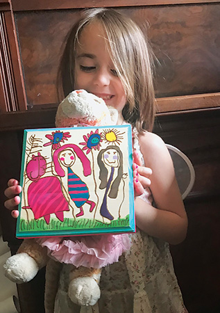 Author's daughter with pyrography piece that she drew