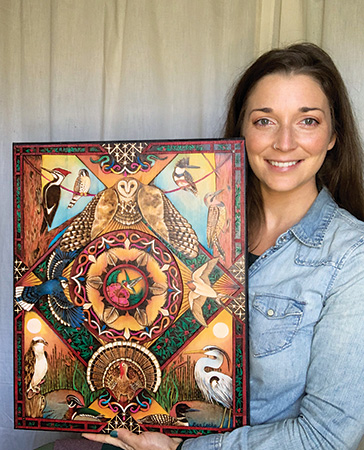 Author holding basswood pyrography art
