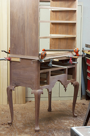 Clamping molding to Queen Anne highboy after gluing and nailing