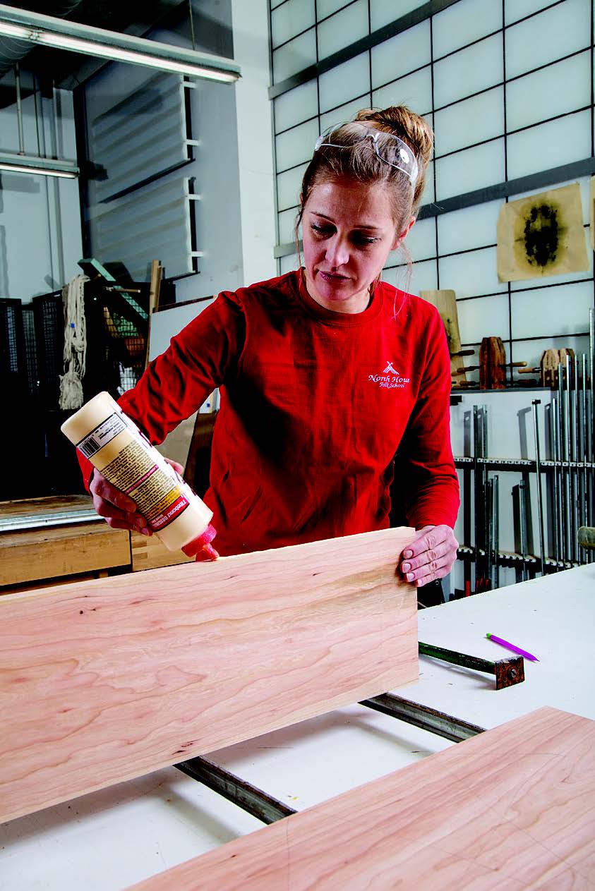 Spreading glue to join tabletop parts