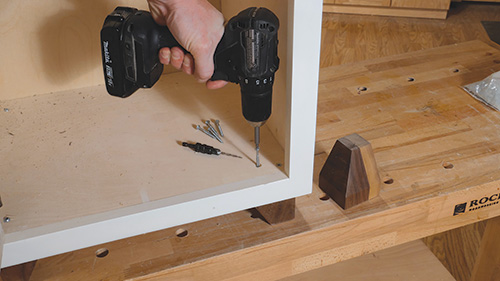 Installing walnut feet into raised panel cabinet base