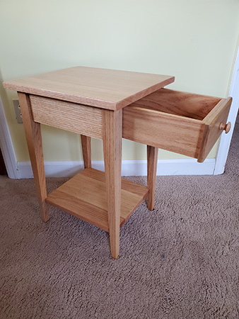 Recliner end table with open drawer