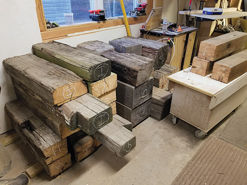 Stacked vintage lumber drying in workshop