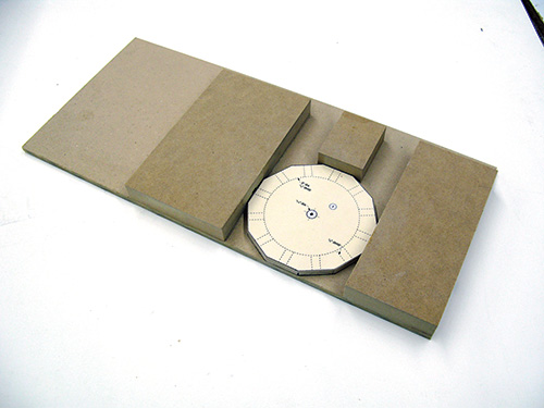 Jig for routing starburst clock with template in place