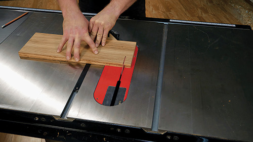 Close-up of cutting laminated wood for gameboard