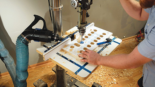 Drilling holes using a paper template guide