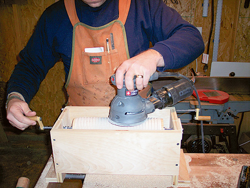 Sanding rolling pin sleeve within rolling pin jig