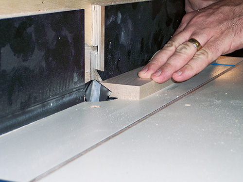 Using a bird's mouth bit in a router table to cut sleeves for a rolling pin