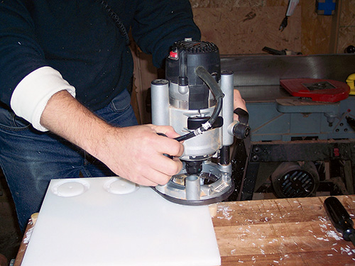 Cutting end caps out of plastic with a trammel and straight bit in a router