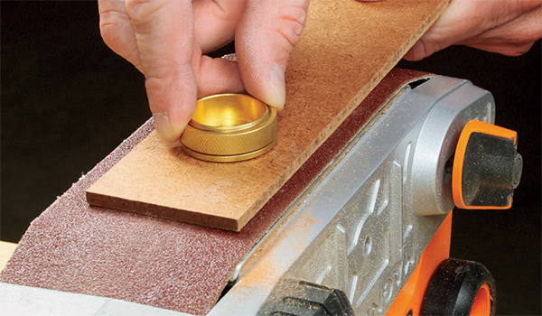 Shortening Router Bushings Safely on a Sander