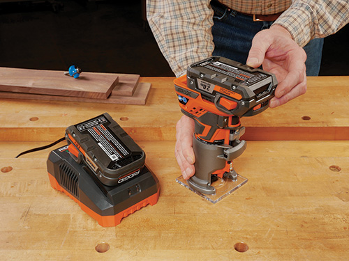Showing off a cordless compact router, battery and charger