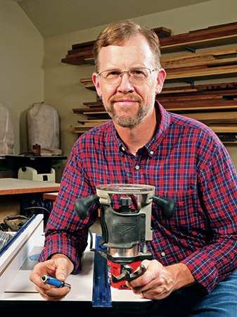 Chris Marshall holding a router and bit