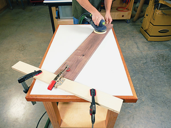 Sanding on workbench with a toggle clamp