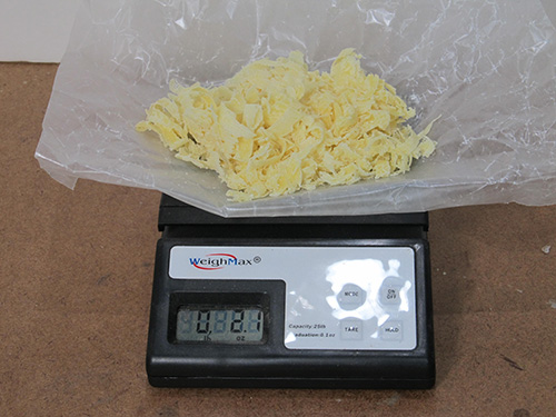 Weighing out beeswax shavings