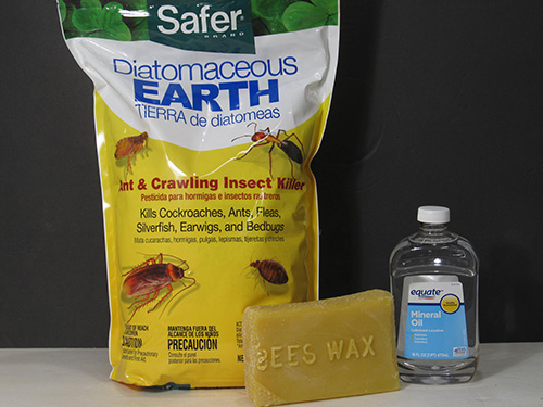 Bag of diatomaceous earth, bar of beeswax and bottle of mineral oil