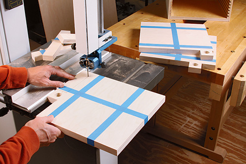 Taping and cutting saw blade organizer panels at the band saw