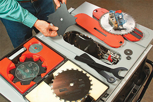 Saw blades laid out on a table saw