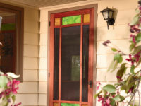 Exterior screen door with colored glass panels