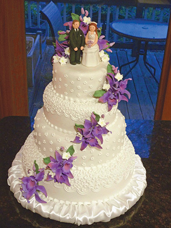 Wedding cake sitting on a scroll sawn base