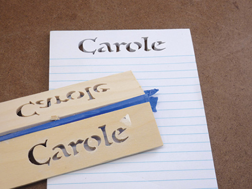 Name cut into notepad header by a scroll saw
