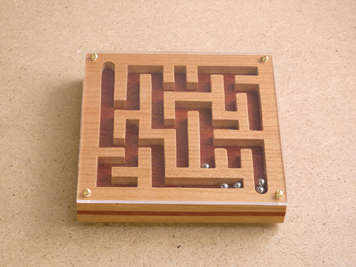 Wooden maze puzzle with an acrylic cover