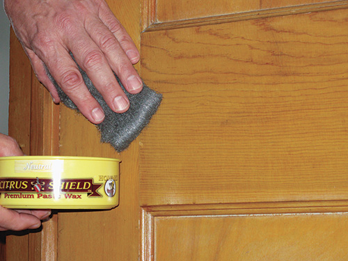 Using steel wool and paste wax to buff out a scuff in lacquer