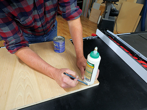 Using glue bottle to mark sewing cabinet foot location